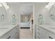 The main bedroom features en suite bath with double sinks and white cabinets at 1551 Beach Rd # 412, Englewood, FL 34223