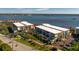 Exterior aerial view of a condo building with palm trees and bay views at 1551 Beach Rd # 412, Englewood, FL 34223