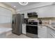 Bright kitchen features stainless steel appliances, granite countertops and ample cabinet space at 1551 Beach Rd # 412, Englewood, FL 34223