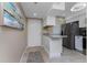Kitchen featuring a breakfast bar and stainless steel appliances at 1551 Beach Rd # 412, Englewood, FL 34223