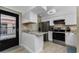 Bright kitchen featuring stainless steel appliances, white cabinets, and a breakfast bar at 1551 Beach Rd # 412, Englewood, FL 34223