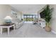 Comfortable living room with a ceiling fan, relaxing seating, and access to a balcony at 1551 Beach Rd # 412, Englewood, FL 34223