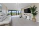 Bright living room with a ceiling fan and sliding glass doors leading to a balcony with views at 1551 Beach Rd # 412, Englewood, FL 34223