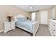 Main bedroom with carpet, a ceiling fan and an en suite bathroom with a barn door at 1551 Beach Rd # 412, Englewood, FL 34223