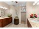 Bathroom featuring dual vanities, granite countertops, decorative accents, and a walk-in shower at 15588 Ruston Cir, Port Charlotte, FL 33981