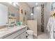 A bright, cheerful bathroom with nautical themed decor and a glass enclosed shower at 15588 Ruston Cir, Port Charlotte, FL 33981