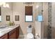 Bathroom featuring a walk-in shower with decorative tiling, a window, and granite countertop at 15588 Ruston Cir, Port Charlotte, FL 33981