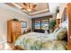 A spacious bedroom with a ceiling fan and access to the patio, offering water views at 15588 Ruston Cir, Port Charlotte, FL 33981