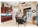 Inviting dining area with dark wood cabinets, a built-in bar, and a picturesque view of the lake at 15588 Ruston Cir, Port Charlotte, FL 33981