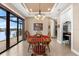 Cozy dining room with tile flooring, a chandelier, and a sliding glass door providing serene lake views at 15588 Ruston Cir, Port Charlotte, FL 33981