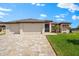 Beautiful single-story home boasts a paver driveway, mature landscaping, and a two-car garage at 15588 Ruston Cir, Port Charlotte, FL 33981
