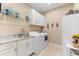 Well-lit laundry room with ample counter space, modern appliances, and stylish decor at 15588 Ruston Cir, Port Charlotte, FL 33981