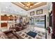 Bright living room featuring tile flooring, ceiling fan, view of the kitchen, and sliding glass doors leading to the pool area at 15588 Ruston Cir, Port Charlotte, FL 33981