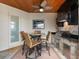 Outdoor kitchen featuring stone accents, a granite countertop, grill, and seating near the water at 15588 Ruston Cir, Port Charlotte, FL 33981