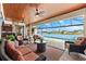 Outdoor living area overlooking the lake, with comfortable seating and a view of the pool at 15588 Ruston Cir, Port Charlotte, FL 33981