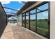 Screened-in pool area with a beach-themed mural and sliding glass doors overlooking the water at 15588 Ruston Cir, Port Charlotte, FL 33981