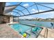 Beautiful waterfront pool with shaded lanai, perfect for relaxing and entertaining at 15588 Ruston Cir, Port Charlotte, FL 33981
