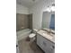 Modern bathroom with a granite counter, vanity, and tiled shower offering comfort and style at 15968 Honeysuckle St, Port Charlotte, FL 33953