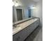 Bathroom with double sinks, granite countertops, and modern fixtures providing an elegant design at 15968 Honeysuckle St, Port Charlotte, FL 33953