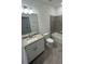 Well-lit bathroom featuring a tub, tiled wall and modern vanity providing a serene and functional space at 15968 Honeysuckle St, Port Charlotte, FL 33953