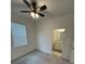 Inviting bedroom with a ceiling fan, natural light, and an en-suite bathroom access at 15968 Honeysuckle St, Port Charlotte, FL 33953