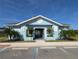 Attractive community clubhouse featuring a welcoming entrance, well-kept landscaping, and ample parking at 15968 Honeysuckle St, Port Charlotte, FL 33953