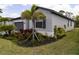 Beautiful single-story home with well-manicured landscaping and a gray stucco exterior at 15968 Honeysuckle St, Port Charlotte, FL 33953