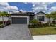 Attractive single-Gathering home with a stone-paved driveway and neatly manicured lawn at 15968 Honeysuckle St, Port Charlotte, FL 33953