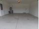 Empty two car garage with door to house at 15968 Honeysuckle St, Port Charlotte, FL 33953