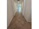 Bright hallway with stylish tile flooring leading into the living area at 15968 Honeysuckle St, Port Charlotte, FL 33953