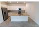 Bright kitchen with stainless steel appliances, granite countertops, and a large island at 15968 Honeysuckle St, Port Charlotte, FL 33953