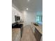 Modern kitchen with white cabinetry, stainless steel appliances and a peninsula island at 15968 Honeysuckle St, Port Charlotte, FL 33953