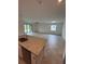 Bright open concept living room flows into kitchen with stylish island and outdoor views at 15968 Honeysuckle St, Port Charlotte, FL 33953