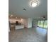 Open-concept living space combining kitchen and living area with large windows at 15968 Honeysuckle St, Port Charlotte, FL 33953