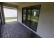 Screened patio with brick floor and view of backyard at 15968 Honeysuckle St, Port Charlotte, FL 33953