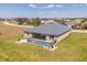 Aerial view of a home featuring a metal roof, fenced pool, and well-kept landscaping at 16489 Trading Post Rd, Punta Gorda, FL 33955