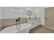 Modern bathroom features dual vanity sinks, a soaking tub, contemporary fixtures, and a neutral color palette at 16489 Trading Post Rd, Punta Gorda, FL 33955