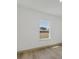 Bedroom with wood floor and view of backyard through window at 16489 Trading Post Rd, Punta Gorda, FL 33955