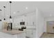 Bright kitchen featuring white cabinets, quartz countertops, and stainless steel appliances at 16489 Trading Post Rd, Punta Gorda, FL 33955