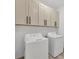Laundry room featuring modern appliances and ample cabinet space for storage at 16489 Trading Post Rd, Punta Gorda, FL 33955