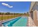 Backyard pool with childproof fence and view of open fields beyond at 16489 Trading Post Rd, Punta Gorda, FL 33955