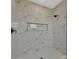 Contemporary walk-in shower with marble-look tile and a built-in niche at 16489 Trading Post Rd, Punta Gorda, FL 33955