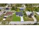 Aerial view of a neighborhood featuring a house with green lawn and paved driveway at 1826 Narrington Ave, North Port, FL 34288
