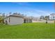 Spacious backyard with a white fence, and a well-maintained lawn at 1826 Narrington Ave, North Port, FL 34288