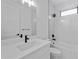 Modern bathroom with white marble walls, quartz countertop, black fixtures, tub, and window at 1826 Narrington Ave, North Port, FL 34288