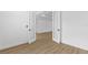 Bright bedroom featuring hardwood floors, white trim, and a double-door entryway at 1826 Narrington Ave, North Port, FL 34288