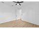 Bright bedroom features ceiling fan, light wood flooring, and white walls, creating a calming atmosphere at 1826 Narrington Ave, North Port, FL 34288