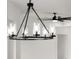 Modern chandelier hanging in a neutral toned room with a ceiling fan at 1826 Narrington Ave, North Port, FL 34288