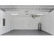 An organized two car garage with white walls, water heater, and electrical panel at 1826 Narrington Ave, North Port, FL 34288