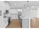 Bright, modern kitchen with stainless appliances, white cabinets, and a center island at 1826 Narrington Ave, North Port, FL 34288